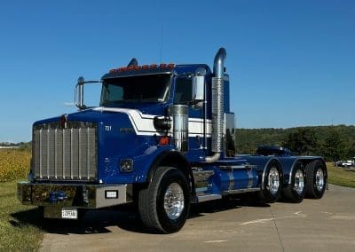 A shiny blue and white custom paint job on a Kenworth semi truck