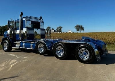 A shiny blue and white custom paint job on a semi truck
